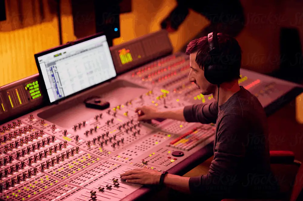 Sound Engineer Mixing Tracks In Music Studio